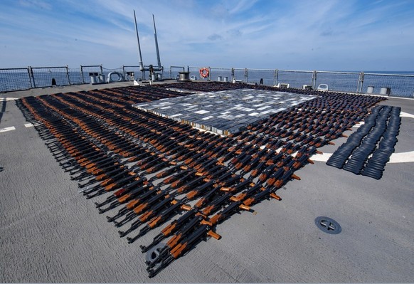 In this Dec. 21, 2021, photo released by the U.S. Navy, Illicit weapons seized from a stateless fishing vessel in the North Arabian Sea are arranged for inventory aboard guided-missile destroyer USS O ...