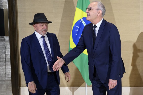Swiss Federal President Guy Parmelin, right, speaks with Brazil's President Luiz Inacio Lula da Silva, left, prior to a bilateral meeting on the sideline of the the Evian G7 summit in Geneva, Swi ...