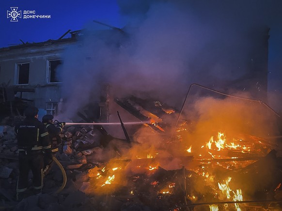 epa11247919 A handout photo made available by the State Emergency Service of Ukraine (SESU) shows rescuers working at the site of a shelling in Hirnyk, Pokrovsk district, Donetsk region, Ukraine, 28 M ...
