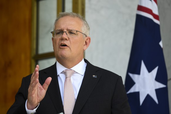 epa09681829 Australian Prime Minister Scott Morrison speaks to the media during a press conference following a national cabinet meeting, at Parliament House in Canberra, Australia, 13 January 2022. EP ...