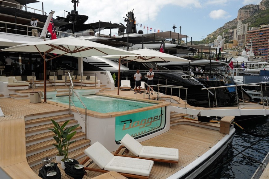 Two men stand on the deck of the superyacht Dagger, which features a swimming pool, at Port Hercule during the Monaco Yacht Show in Monaco on September 23, 2026. This is the 35th edition of the Monaco ...