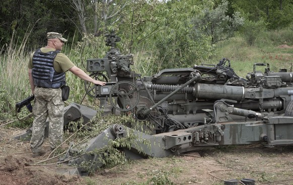 A Ukrainian soldier stands at a U.S.-supplied M777 howitzer in Ukraine&#039;s eastern Donetsk region Saturday, June 18, 2022. (AP Photo/Efrem Lukatsky)