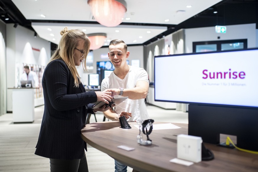 [Staged Picture] An employee (right) talks to a customer (left) in a shop of the telecommunications provider Sunrise Communications in Glattbrugg, Canton of Zurich, Switzerland, on February 19, 2019.  ...