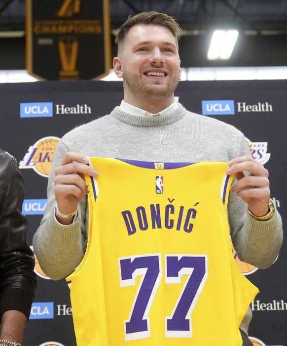Los Angeles Lakers&#039; Luka Doncic poses for photos with his new jersey during an introductory NBA basketball press conference Tuesday, Feb. 4, 2025, in El Segundo, Calif. (AP Photo/Jae C. Hong)