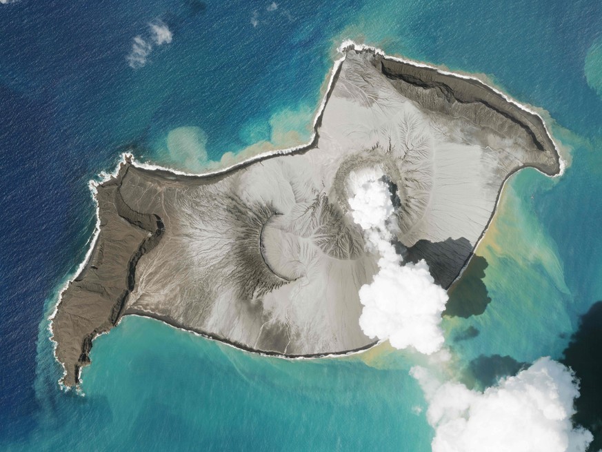 In this satellite photo taken by Planet Labs PBC, an island created by the underwater Hunga Tonga Hunga Ha&#039;apai volcano is seen smoking Jan. 7, 2022. An undersea volcano erupted in spectacular fa ...