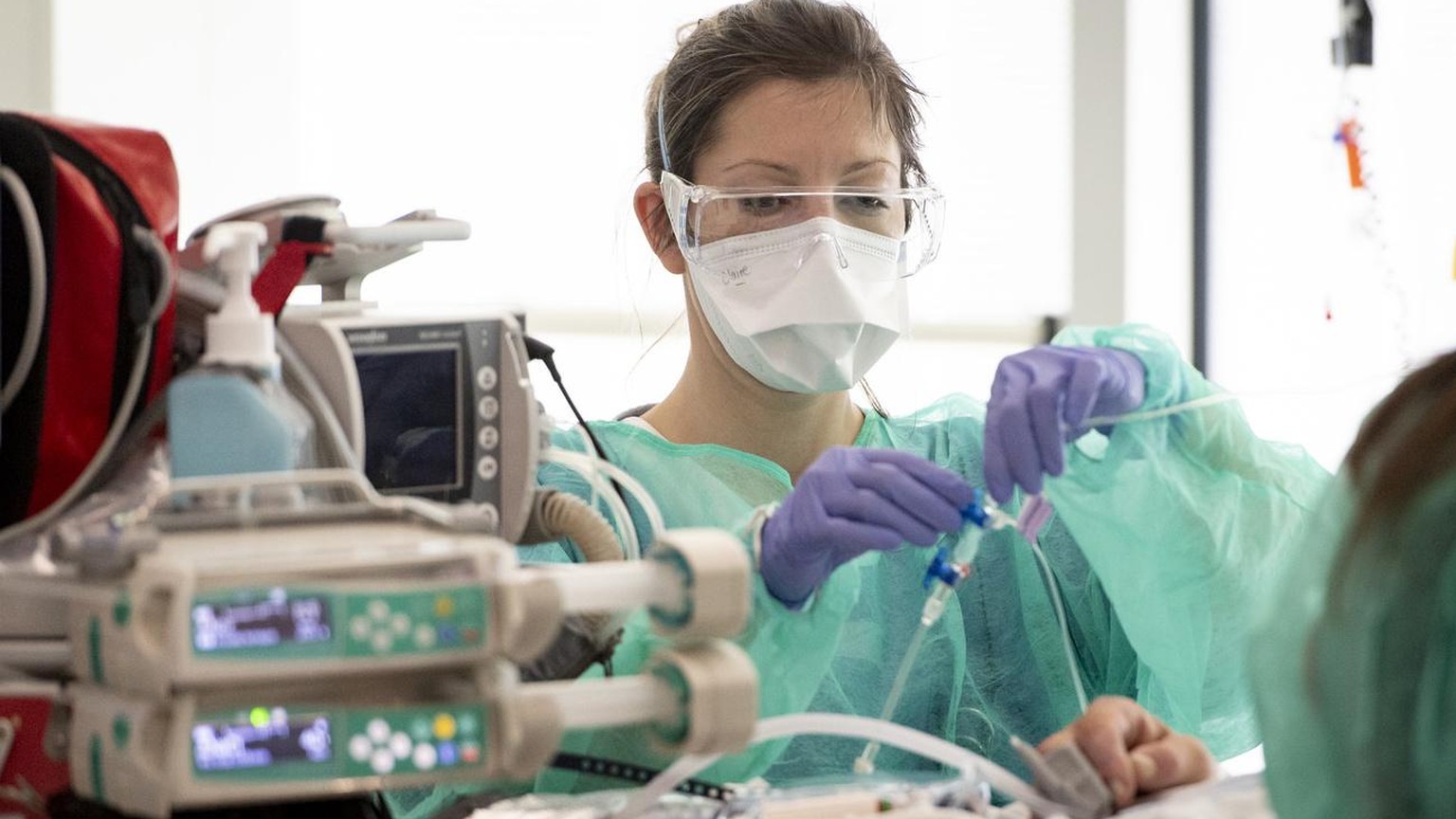 Medical worker treats a patient with COVID-19 in the intensive care unit at the HRC Hospital (Hopital Riviera-Chablais Vaud-Valais) during the state of emergency of the coronavirus disease (COVID-19)  ...