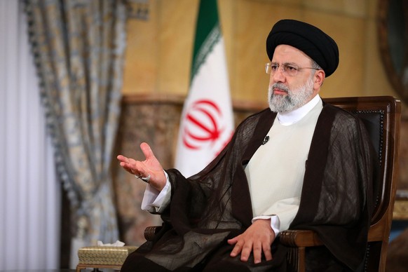 In this photo released by the official website of the office of the Iranian Presidency, President Ebrahim Raisi speaks in an interview with the state TV at the presidency office in Tehran, Iran, Wedne ...