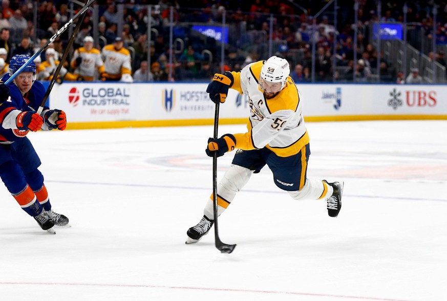 Nashville Predators defenseman Roman Josi, right, shoots and scores the winning goal in the third period of an NHL hockey game against the New York Islanders, Saturday, Jan. 31, 2026, in Elmont, N.Y.  ...
