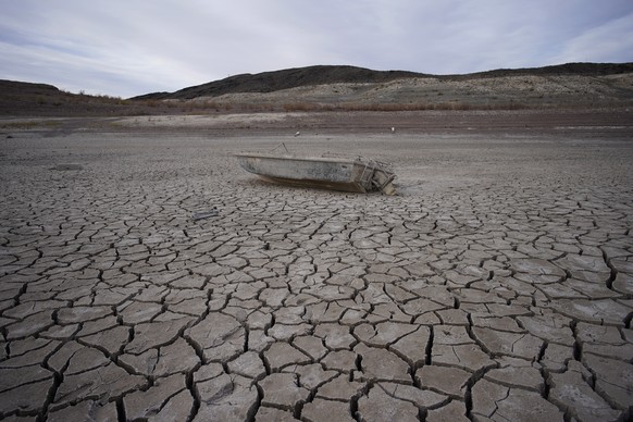 FILE - A formerly sunken boat sits on cracked earth hundreds of feet from the shoreline of Lake Mead at the Lake Mead National Recreation Area on May 10, 2022, near Boulder City, Nev. Another body has ...