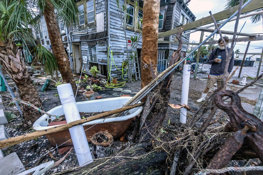 epa11652497 A man looks on debris after Hurricane Milton swept through Bradenton, Florida, USA, 10 October 2024. According to the National Hurricane Center, Hurricane Milton made landfall on the west  ...