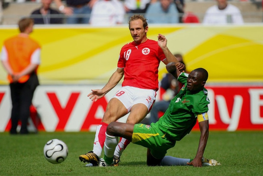 DORTMUND, GERMANY - June 19: Mauro Lustrinelli of Switzerland and Massamasso Tchangai of Togo challenge during the FIFA World Cup Finals 2006 Group G match between Togo and Switzerland at Westfalensta ...