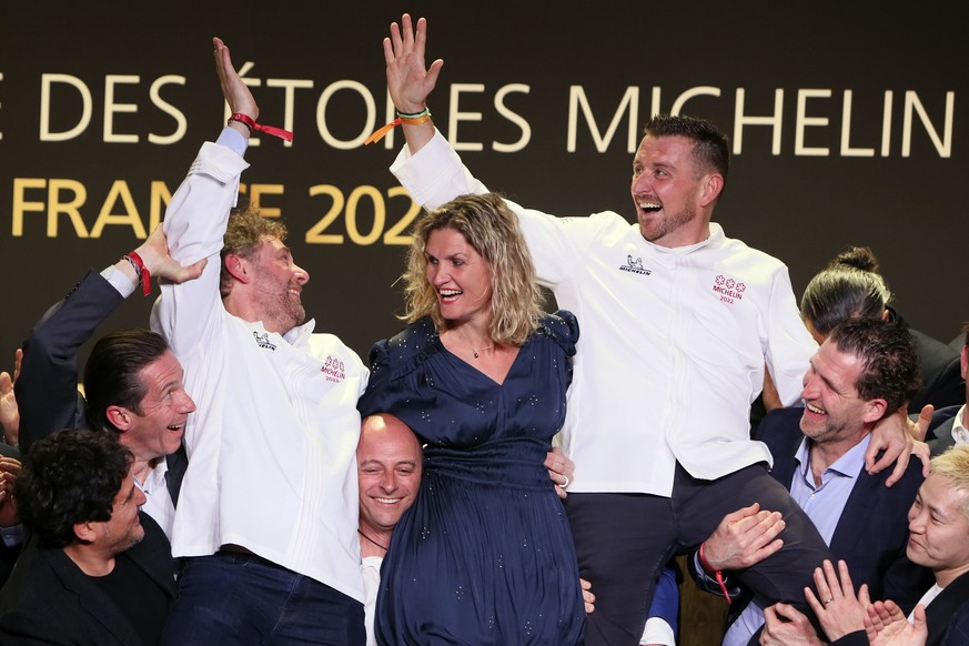 French chefs Dimitri Droisneau, center left , and Dimitri Droisneau, center, right, celebrate on stage as they get three stars at the 2022 Michelin guide, during the Michelin guide ceremony in Cognac, ...
