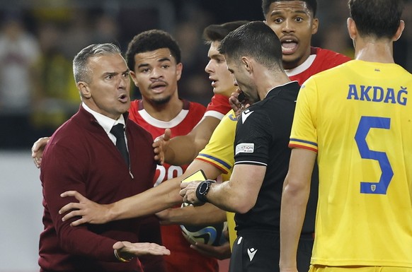 epa11660796 Romania head coach Daniel Pancu (L) argues with Referee Marc Nagtegaal (3-R) before receiving a red card during the 2025 UEFA European Under-21 Championship qualifier soccer match between  ...