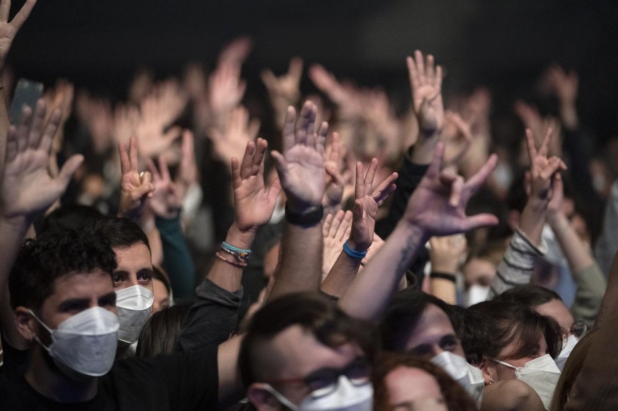 People attend a music concert in Barcelona, Spain, Saturday, March 27, 2021. Five thousand music lovers are set to attend a rock concert in Barcelona on Saturday after passing a same-day COVID-19 scre ...