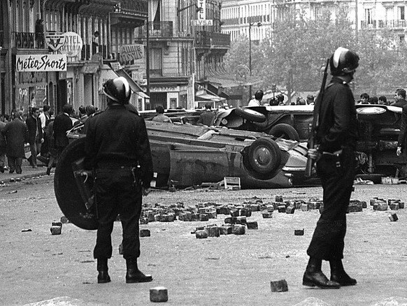 FRANKREICH, PARIS, MAI 1968: Riot police stand guard near overturned cars after a night of riots in Paris May 11, 1968. Thirty years later, France is still grappling with the legacy of the would-be st ...