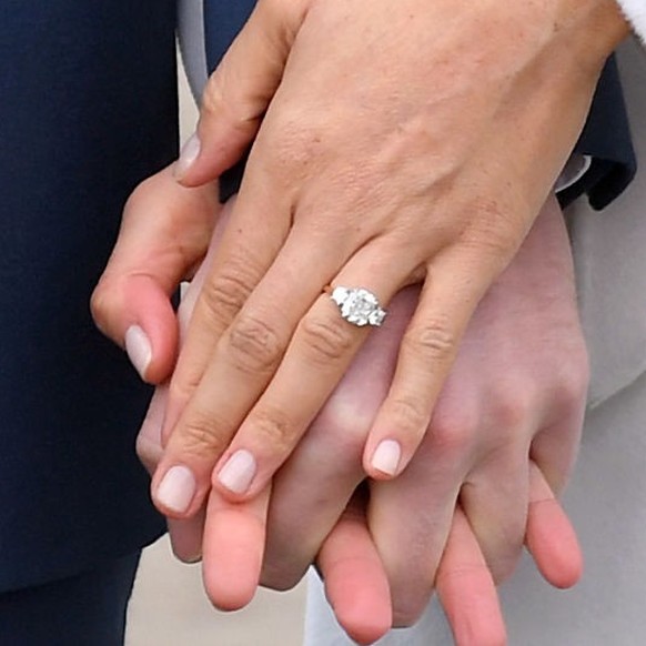 LONDON, ENGLAND - NOVEMBER 27: Prince Harry and Meghan Markle, ring detail, attend an official photocall to announce the engagement of Prince Harry and actress Meghan Markle at The Sunken Gardens at K ...