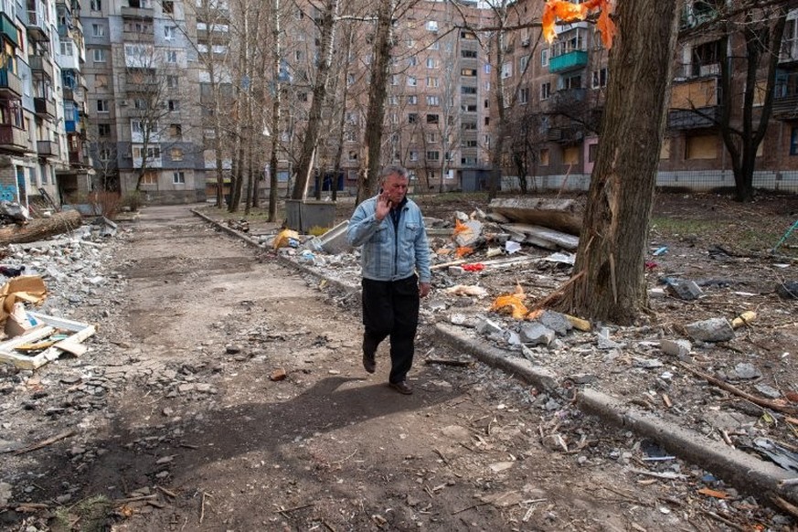 Un homme passe devant des immeubles résidentiels endommagés par des frappes de bombes glissantes russes dans la ville de Kostiantynivka, située en première ligne dans la région du Donbass.
