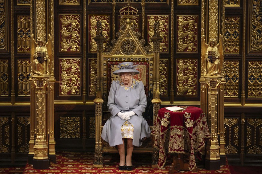 FILE - Britain&#039;s Queen Elizabeth II delivers a speech in the House of Lords during the State Opening of Parliament at the Palace of Westminster in London May 11, 2021. Buckingham Palace says Quee ...