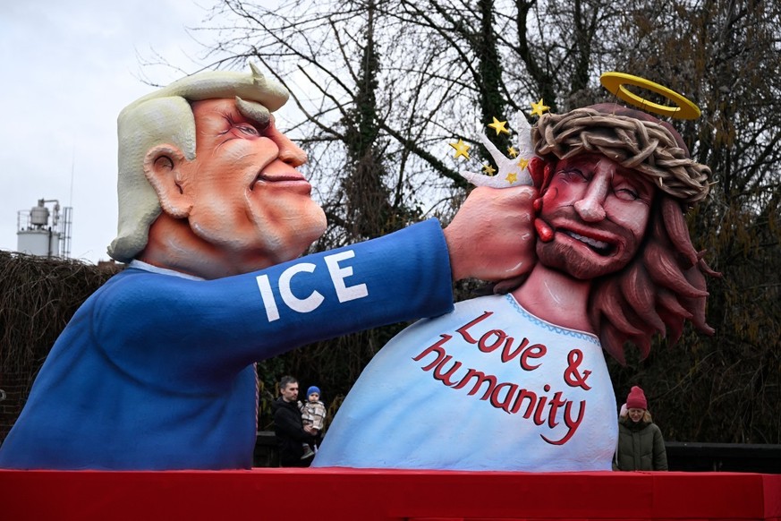 A carnival float designed by German carnival float builder Jacques Tilly featuring US President Donald Trump is pictured during the parade to celebrate Rose Monday (Rosenmontag), on February 16, 2026  ...