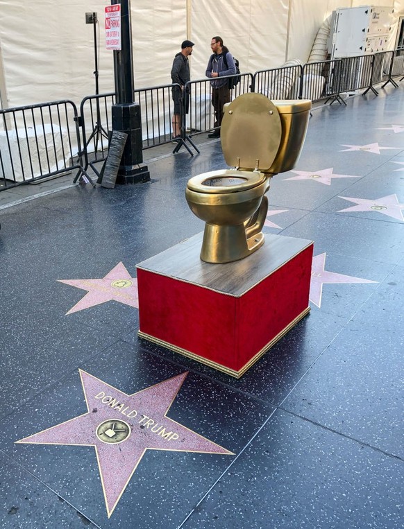 HOLLYWOOD, CA - DECEMBER 15: A golden toilet created by a political street artist is left near the star of Donald Trump on the Hollywood Walk of Fame on December 15, 2019 in Hollywood, California. (Ph ...