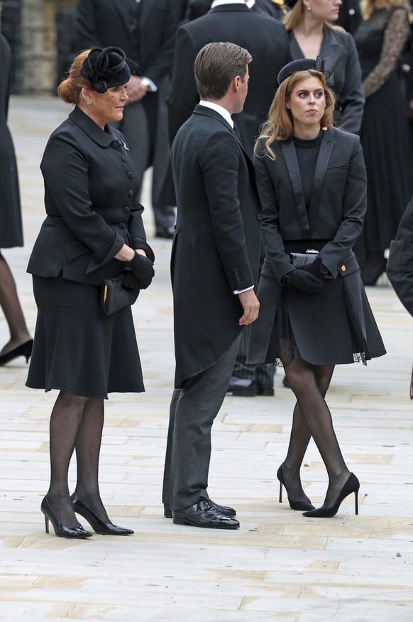 Sarah Ferguson, left, her daughter Princess Beatrice right and her husband Edoardo Mapelli Mozzi stand outside Westminster Abbey ahead of the State Funeral of Queen Elizabeth II, in London, Monday Sep ...