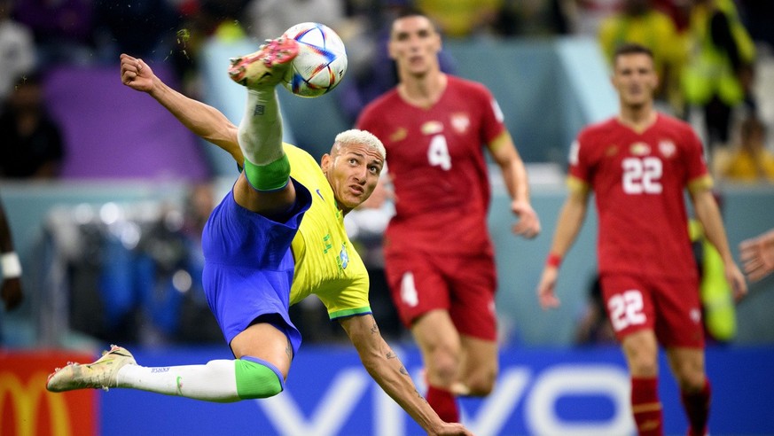 Brazil&#039;s forward Richarlison, left, scores the second goal for his team in front of Serbia&#039;s defender Nikola Milenkovic, center, and Serbia&#039;s midfielder Darko Lazovic, right, during the ...