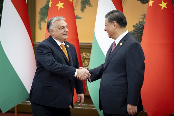 In this picture issued by the Hungarian PM&#039;s Press Office, Chinese President Xi Jinping, right, receives Hungarian Prime Minister Viktor Orban before their bilateral meeting in the Great Hall of  ...