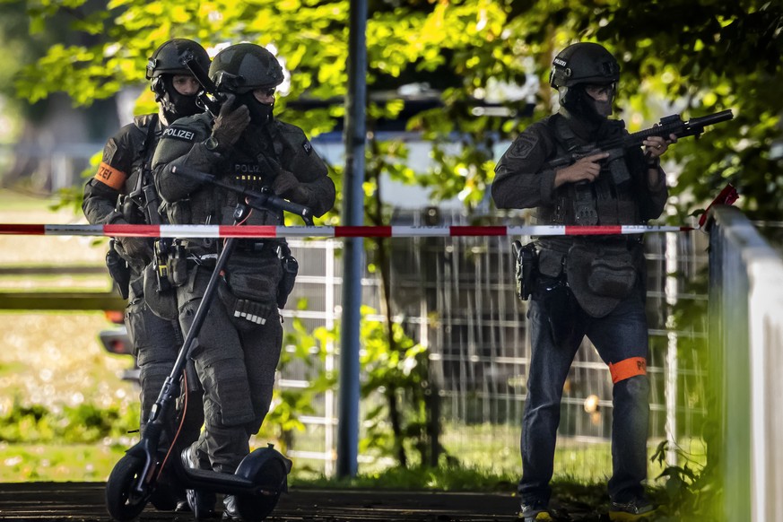 Armed police officers patrol near the Schachen horse racing track in Aarau following a shooting during a rave event at the Schachen horse racing track near Aarau, Switzerland on Sunday, August 30, 202 ...