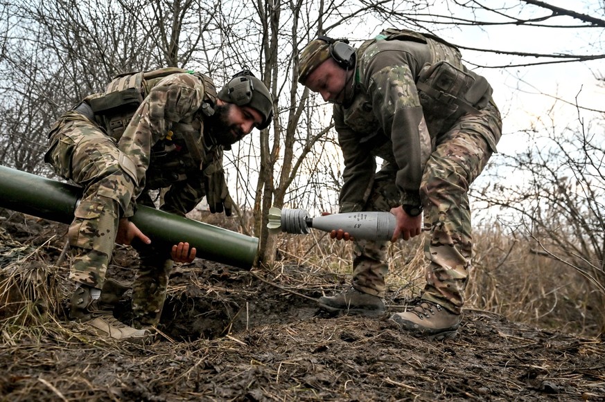 Mortar unit of Ukraine s Khyzhak Patrol Police Special Unit In the Donetsk region, Ukraine, on December 20, 2024, servicemen of Ukraine s Khyzhak Patrol Police Special Unit load a mortar while on a co ...