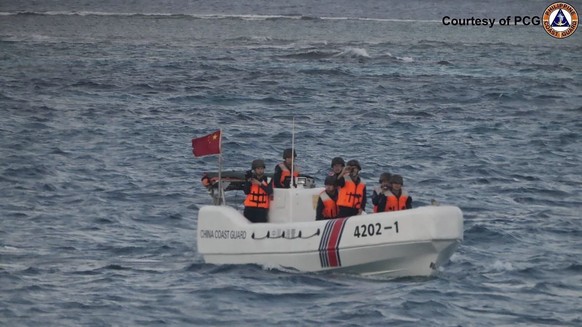 In this image released by Philippine Coast Guard, a Chinese Coast Guard boat sails around Sandy Cay in the South China Sea Friday, Jan. 24, 2025. (Philippine Coast Guard via AP)
