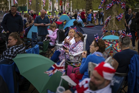 Royal fans gather along the King&#039;s Coronation route at The Mall in London, Friday, May 5, 2023. The Coronation of King Charles III will take place at Westminster Abbey on May 6. (AP Photo/Emilio  ...