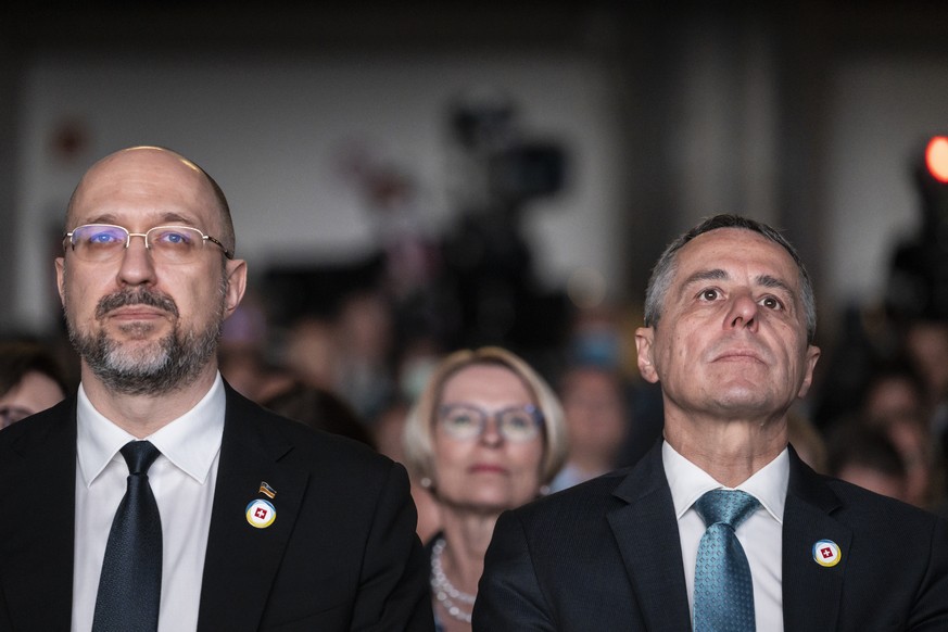 Swiss President Ignazio Cassis, Minister of Foreign Affairs, right, and Ukrainian Prime Minister Denys Shmyhal, right, with Swiss Secetary of State Livia Leu, center, participate in the closing plenar ...