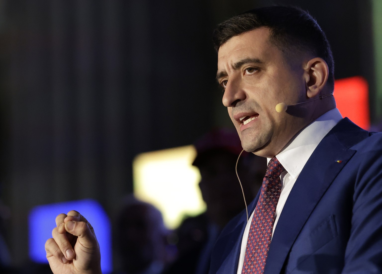 epa12114441 George Simion, presidential candidate and leader of the far-right Alliance for the Union of Romanians (AUR), delivers his speech before the first exit poll results of the presidential runo ...
