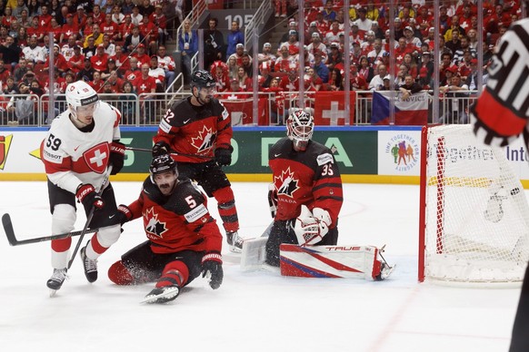 Switzerland&#039;s forward Dario Simion #59 scores the 1:2 against Canada&#039;s goaltender Samuel Montembeault, right, past Canada&#039;s defender Jacob Middleton #5d and Canada&#039;s defender MacKe ...