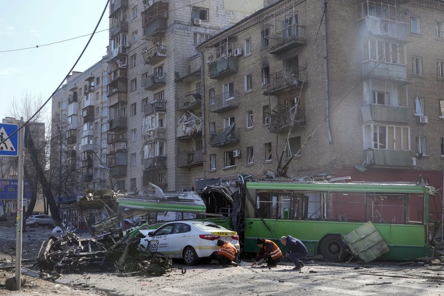 Police inspect the site of a Russian bombing attack in Kyiv, Ukraine, Monday, March 14, 2022. (AP Photo/Efrem Lukatsky)