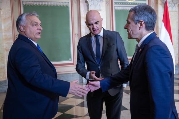 Switzerland&#039;s President Alain Berset, center, and Switzerland&#039;s Federal Councilor Ignazio Cassis, right, welcome Hungary&#039;s Prime Minister Viktor Orban during a working visit, in Bern, S ...