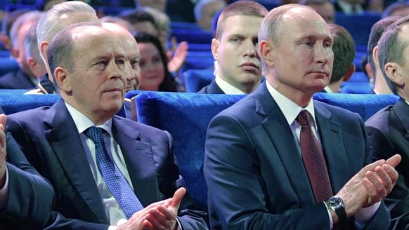 epa08746757 (FILE) - Russian President Vladimir Putin (R) and Federal Security Service Director Alexander Bortnikov (L) attend a concert marking Russian Security Service Officer Day, in Moscow, Russia ...