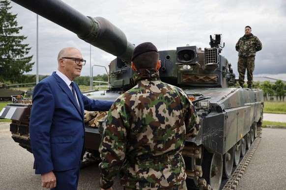 Le conseiller fédéral Martin Pfister devant un char Leopard 2. Il souhaite davantage de moyens financiers pour l&#039;armée.