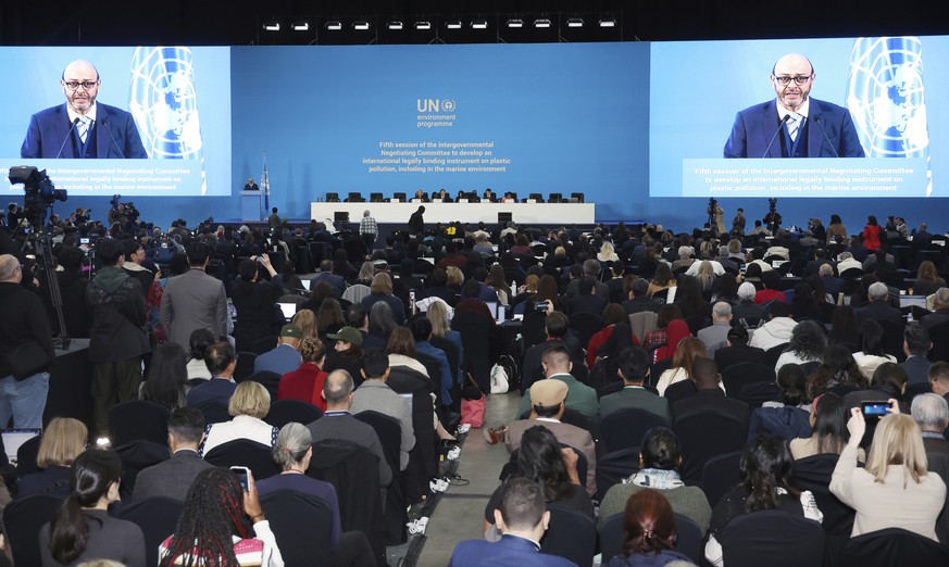 Chair of the International Negotiating Committee, Luis Vayas Valdivieso, on the screen, speaks during the opening ceremony of the fifth session of the Intergovernmental Negotiating Committee on Plasti ...