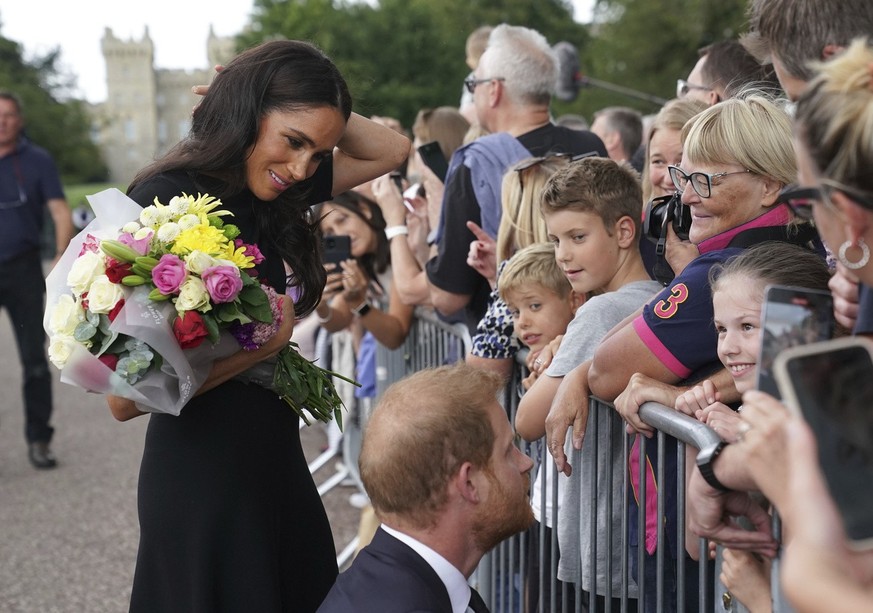 Meghan, Duchess of Sussex and Prince Harry meet members of the public on a walkabout at Windsor Castle, following the death of Queen Elizabeth II on Thursday, in Windsor, England, Saturday, Sept. 10,  ...