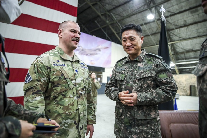 epa10364750 Lt. Col. Joshua McCullion (L), Commander of the US Space Forces Korea, talks with South Korean Gen. Ahn Byung-seok, deputy commander of the South Korea-US Combined Forces Command, during a ...
