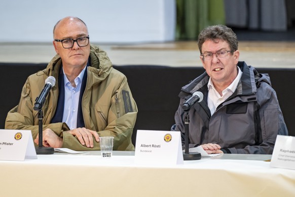 epa12141606 Swiss Federal Councillor Martin Pfister (L) and Swiss Federal Councillor Albert Roesti (R) speak during a press conference in Ferden, Switzerland, 28 May 2025. A large part of Blatten vill ...
