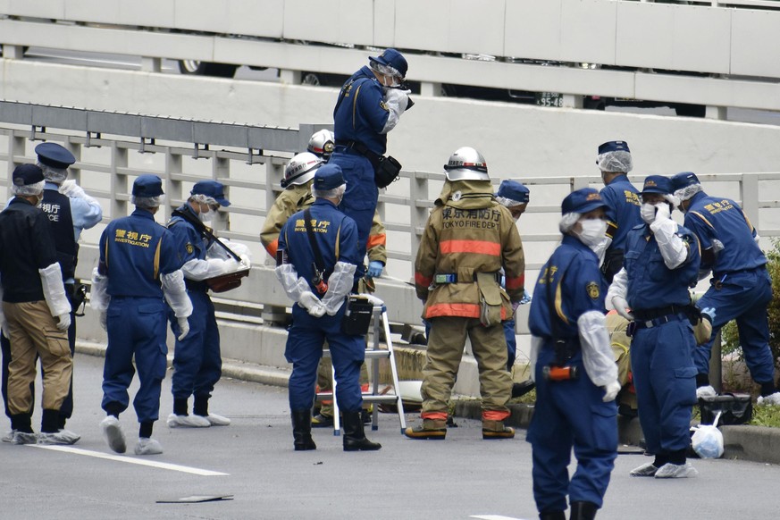 Police and firefighters inspect the scene where a man is reported to set himself on fire, near the Prime Minister&#039;s Office in Tokyo, Wednesday, Sept. 21, 2022. The man was taken to a hospital Wed ...