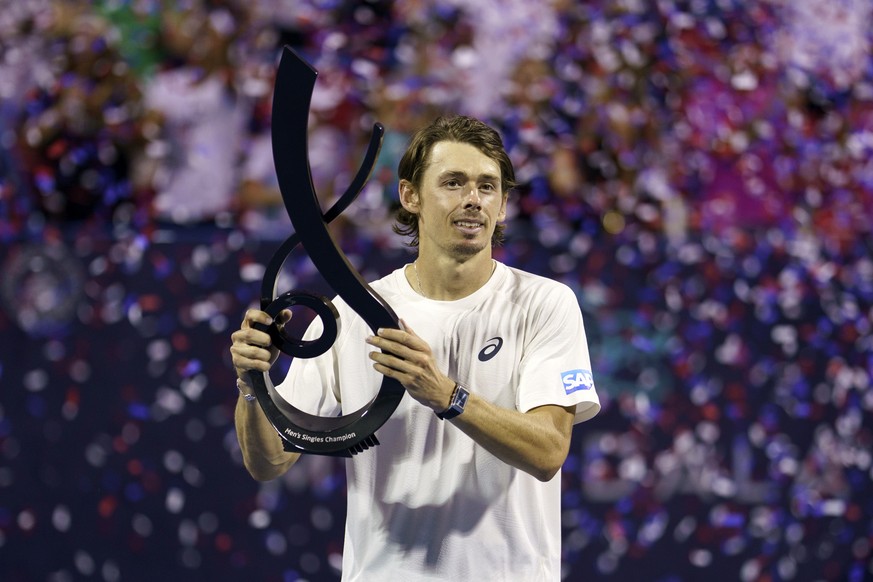 epa12267080 Australia?s Alex de Minaur lifts the champions trophy after defeating Spain?s Alejandro Davidovich Fokina during their men?s singles final match at the Mubadala Citi DC Open tennis tournam ...