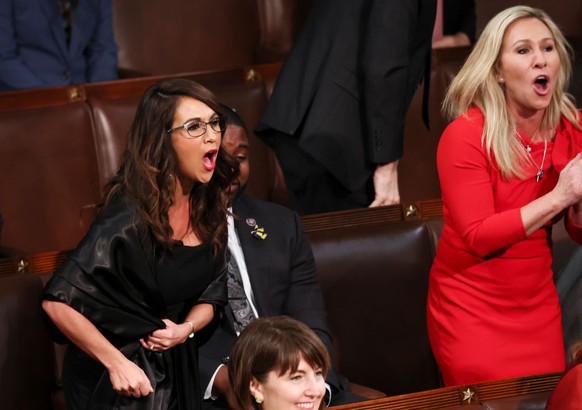 WASHINGTON, DC - MARCH 01: U.S. Rep. Lauren Boebert (R-CO) and Rep. Marjorie Taylor Greene (R-GA) scream &quot;Build the Wall&quot; as U.S. President Joe Biden delivers the State of the Union address  ...