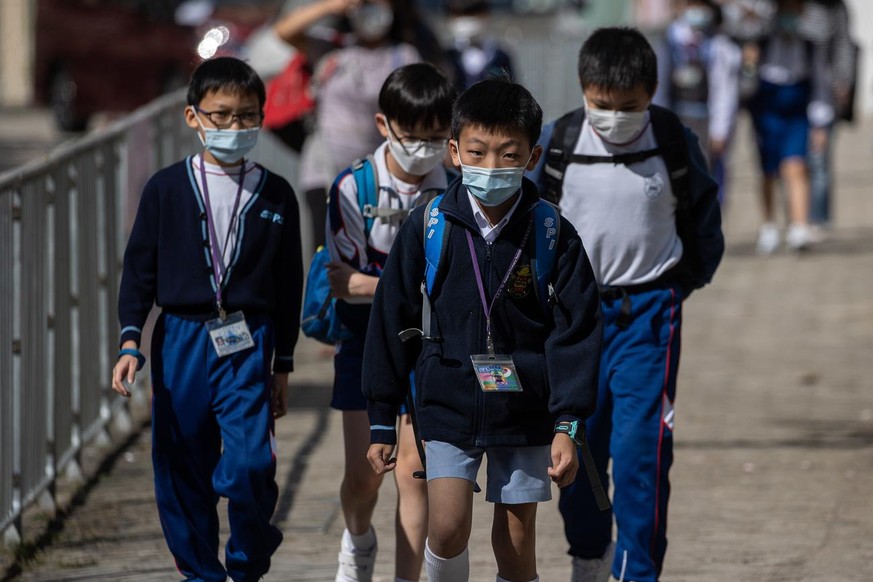 Students walk home after school in Hong Kong, China, 30 November 2020. The Hong Kong government announced that all primary and secondary schools must suspend in-person classes from 02 December until y ...