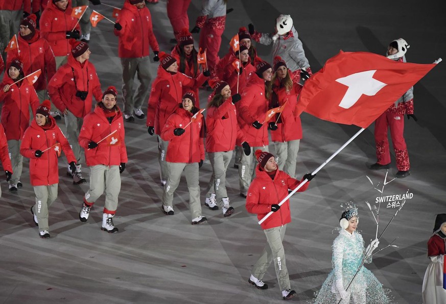 Dario Cologna carries the flag of Switzerland during the opening ceremony of the 2018 Winter Olympics in Pyeongchang, South Korea, Friday, Feb. 9, 2018. (Franck Fife/Pool Photo via AP)