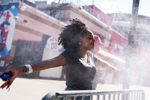 UNITED STATES - JUNE 12: A fan cools off in mist before the Congressional Baseball Game at Nationals Park on Wednesday, June 12, 2024.(Tom Williams/CQ-Roll Call, Inc via Getty Images)