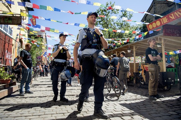 FILE - Police patrol Pusher Street in at Christiania, Copenhagen, Friday, May 25, 2018, after the street reopened after having been closed for three days. Copenhagen?s mayor is urging urged foreigners ...