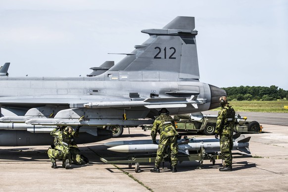 Des soldats suédois installent des missiles Meteor sous un avion Gripen : le pays scandinave a mis cette arme en service en 2016.